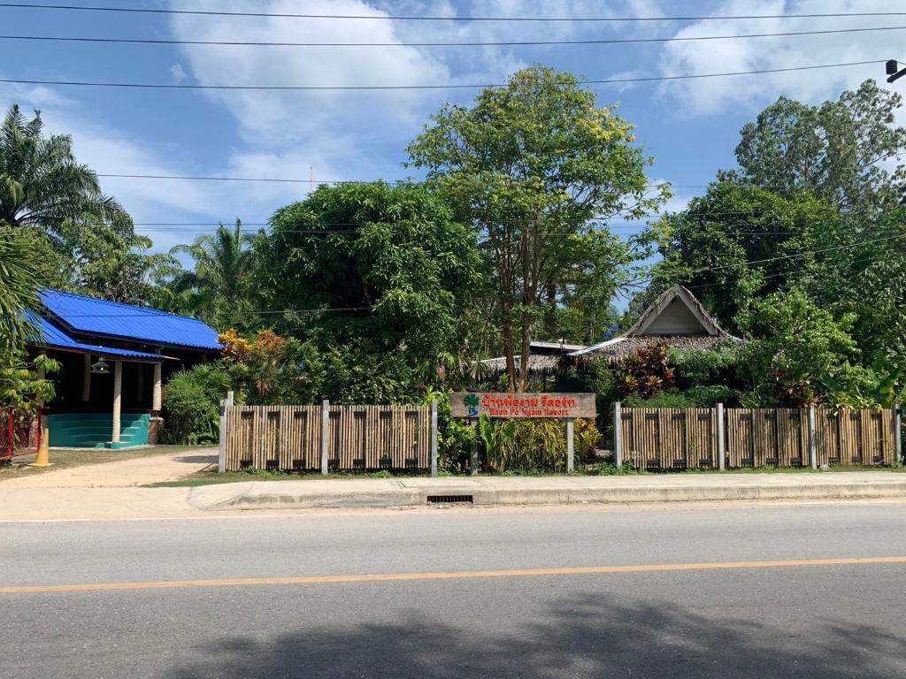 a house on the side of a street with a fence at Baan Pongam Resort in Ao Nang Beach