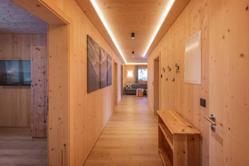 a hallway of a house with wooden walls and a wooden bench at Luxury Naturperle Haus Alpenprinzessin helles Holzhaus zentral , modern & großräumig in Neustift im Stubaital