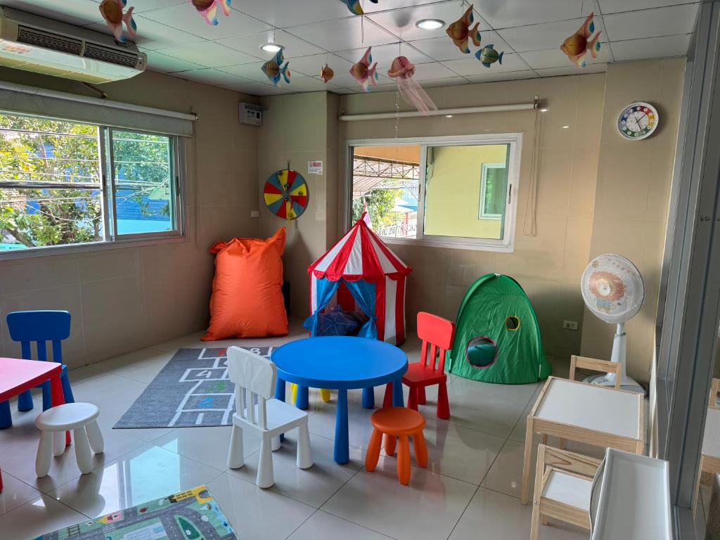 a room with a table and chairs and a playroom at Sivalai Place in Bangkok