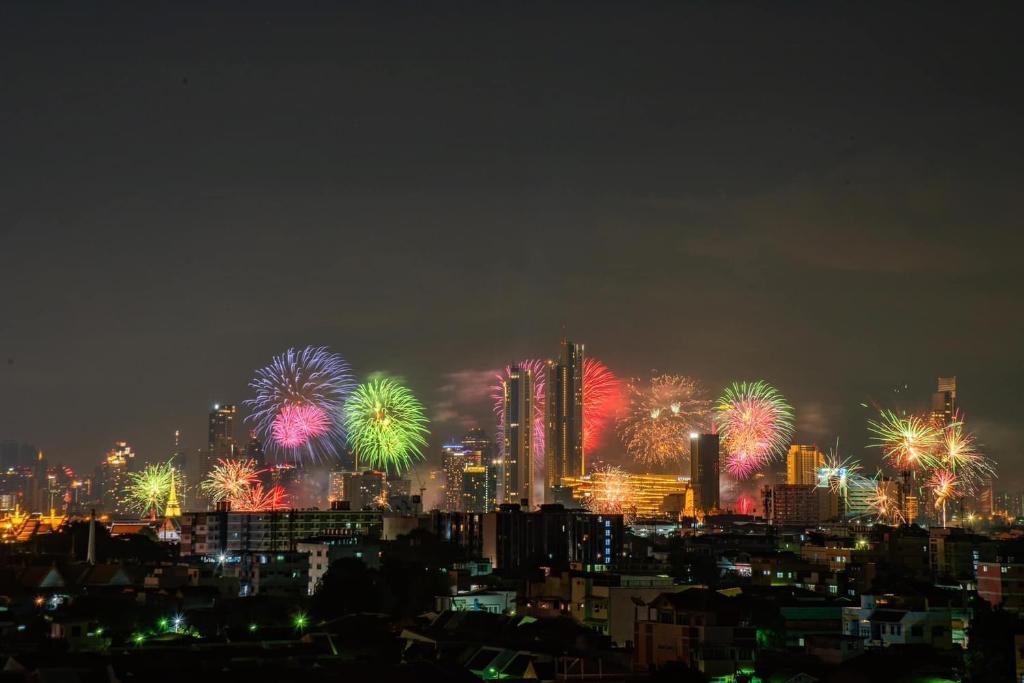 a city skyline with fireworks in the sky at night at Sivalai Place in Bangkok