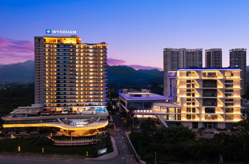 a tall building with a sign on the top of it at Wyndham Nankunshan in Cenkeng