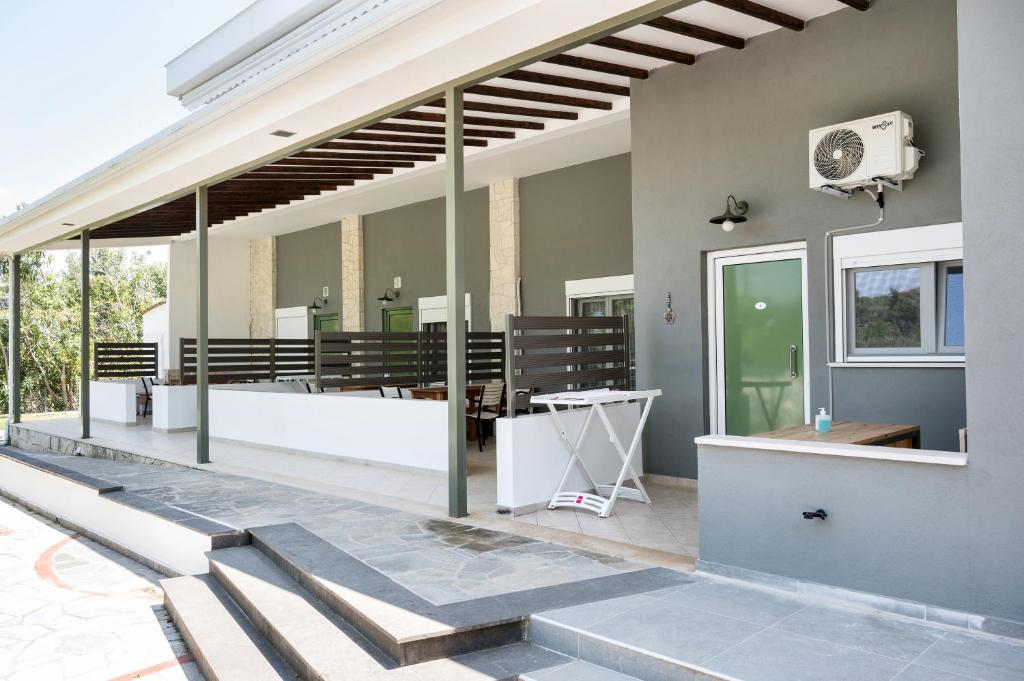 a patio with a row of benches on a building at Istira in Possidi