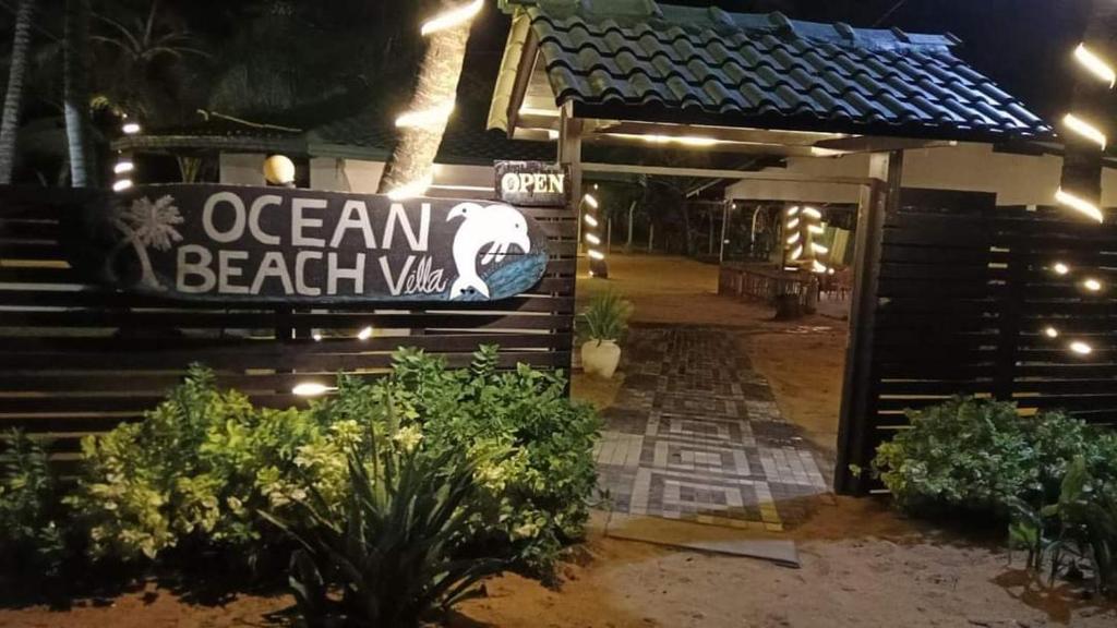 an entrance to an ocean beach villa at night at Ocean Villa in Panadura