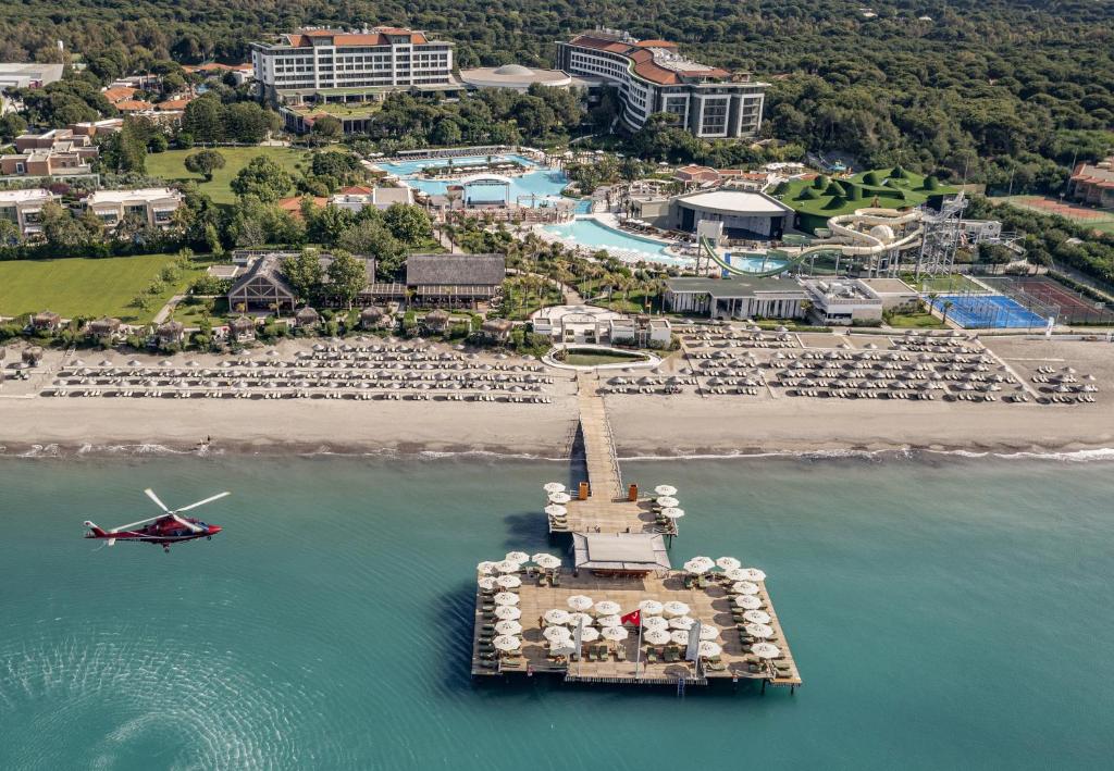an aerial view of a resort with a boat in the water at Ela Excellence Resort Belek in Belek