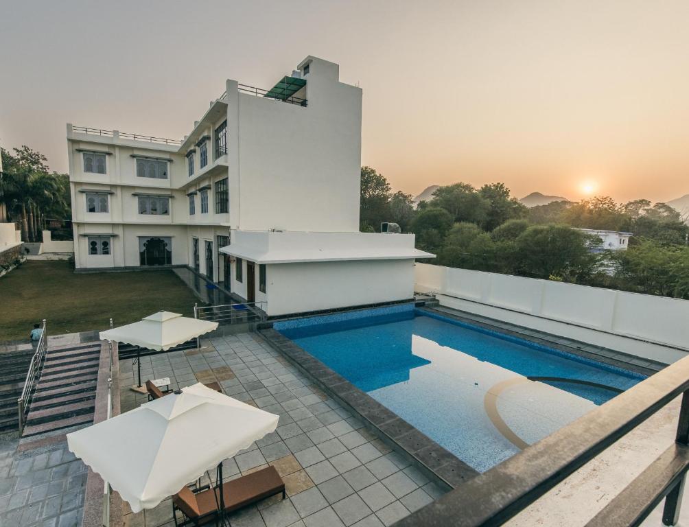 a pool on the roof of a building at Serenity Hill Resort & Spa in Udaipur