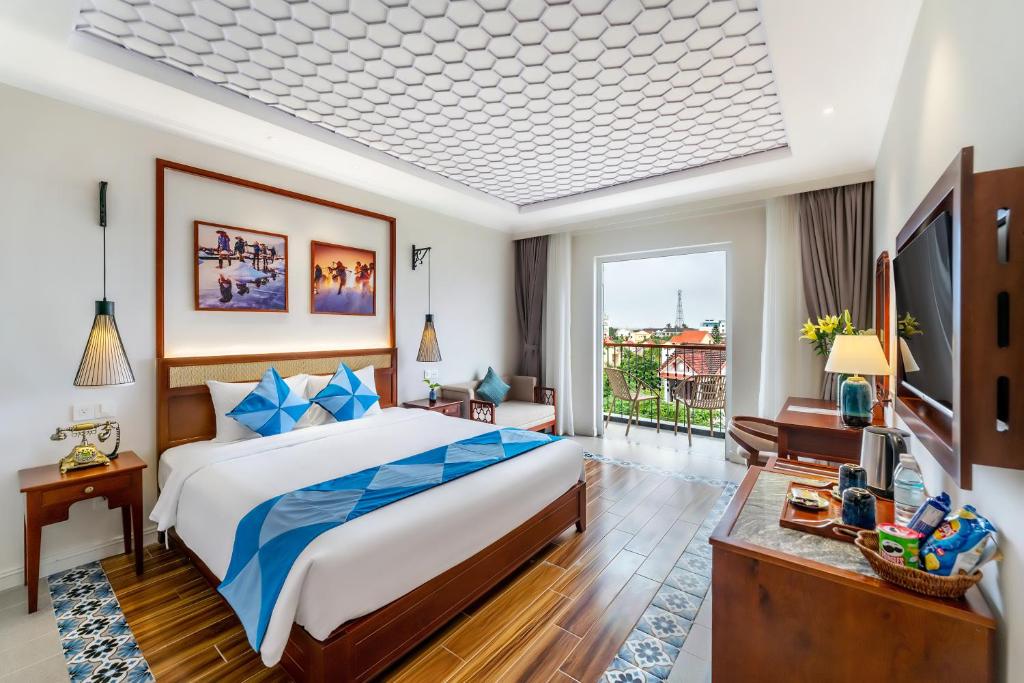 Giường trong phòng chung tại Amina Lantana Hoi An Hotel & Spa