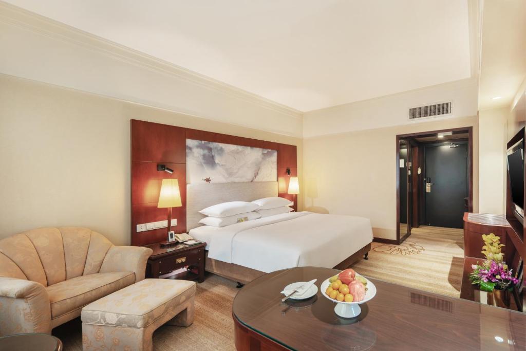 Postel nebo postele na pokoji v ubytování Shenzhen Sunshine Hotel, Luohu