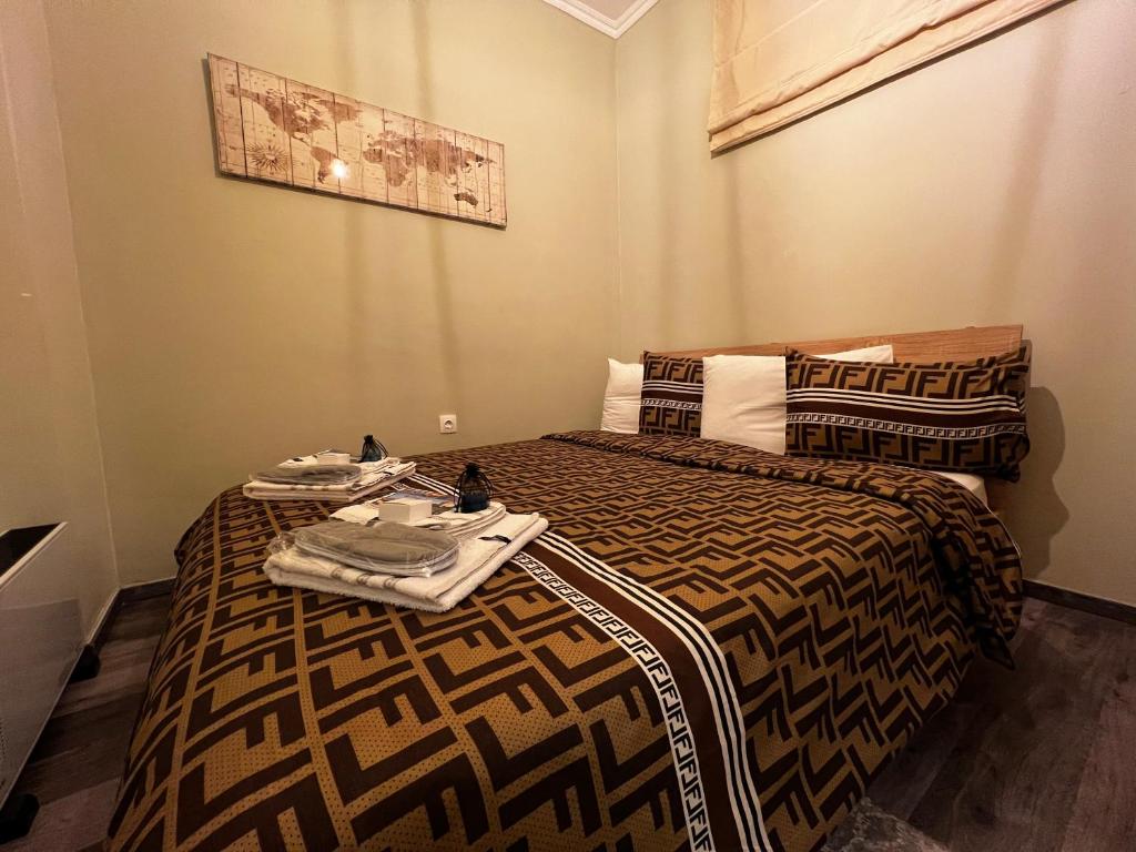 a bedroom with two beds with towels on them at Diamond in Thessaloniki