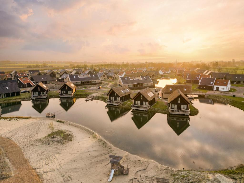 an aerial view of a village with houses on the water at Dormio Resort Nieuwvliet-Bad in Nieuwvliet