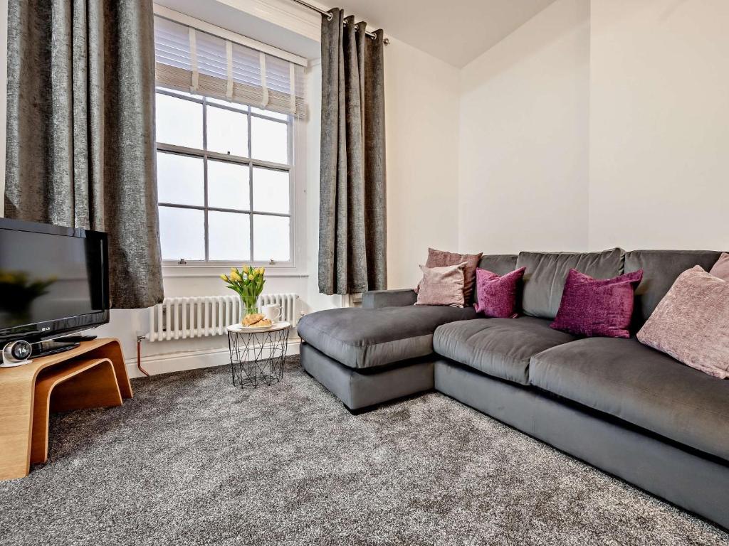 a living room with a couch and a tv at 1 Bed in Allonby 91113 in Allonby