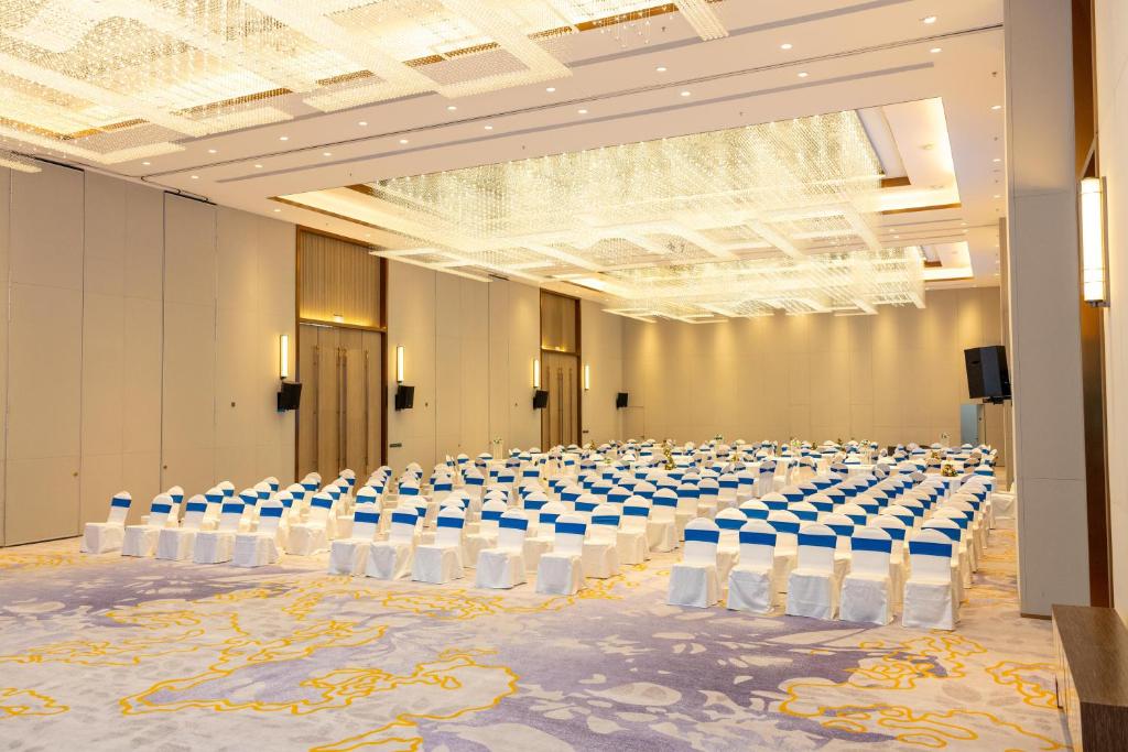 a large room with tables and chairs in it at Argyle Grand Hotel Nairobi Airport in Nairobi