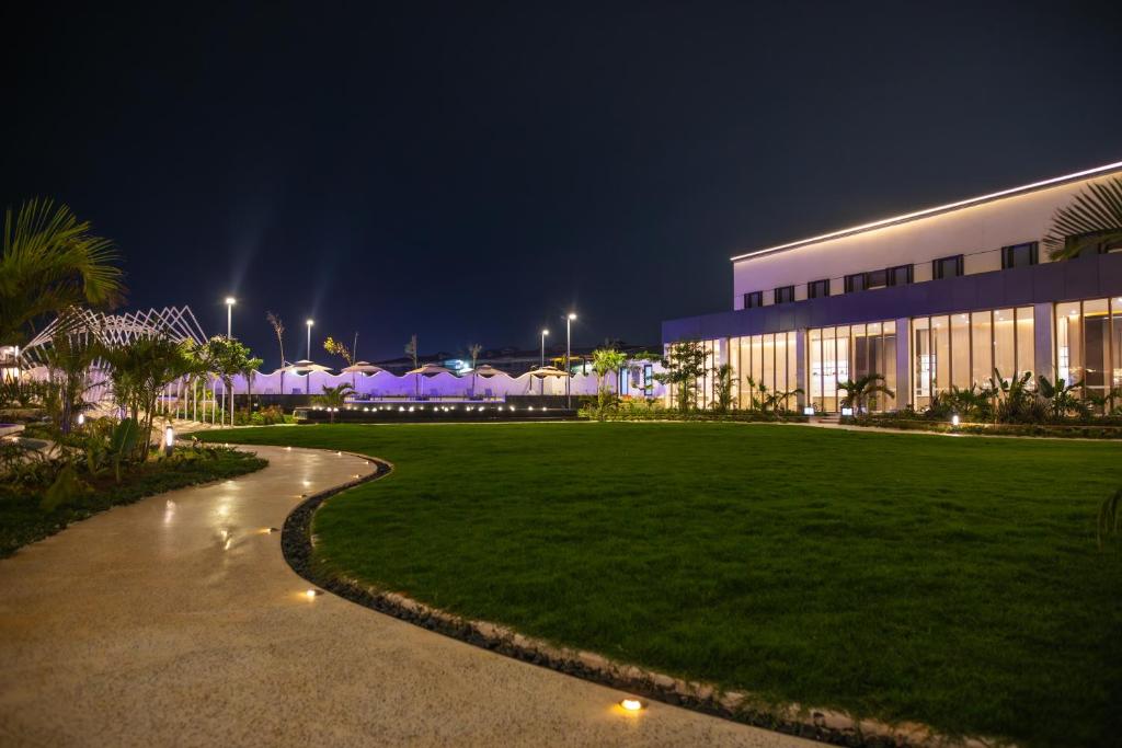 a building with a lawn in front of it at night at Argyle Grand Hotel Nairobi Airport in Nairobi