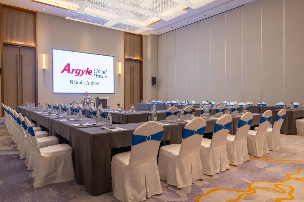 a conference room with a long table and chairs at Argyle Grand Hotel Nairobi Airport in Nairobi