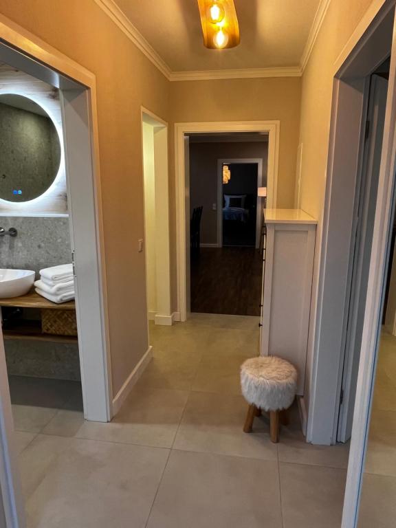 a hallway of a bathroom with a table and a stool at Ferienwohnung Spiemont in Sankt Wendel