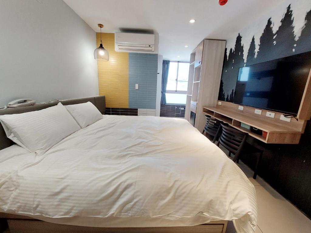 Postel nebo postele na pokoji v ubytování 安平商旅Choona Hotel Anping