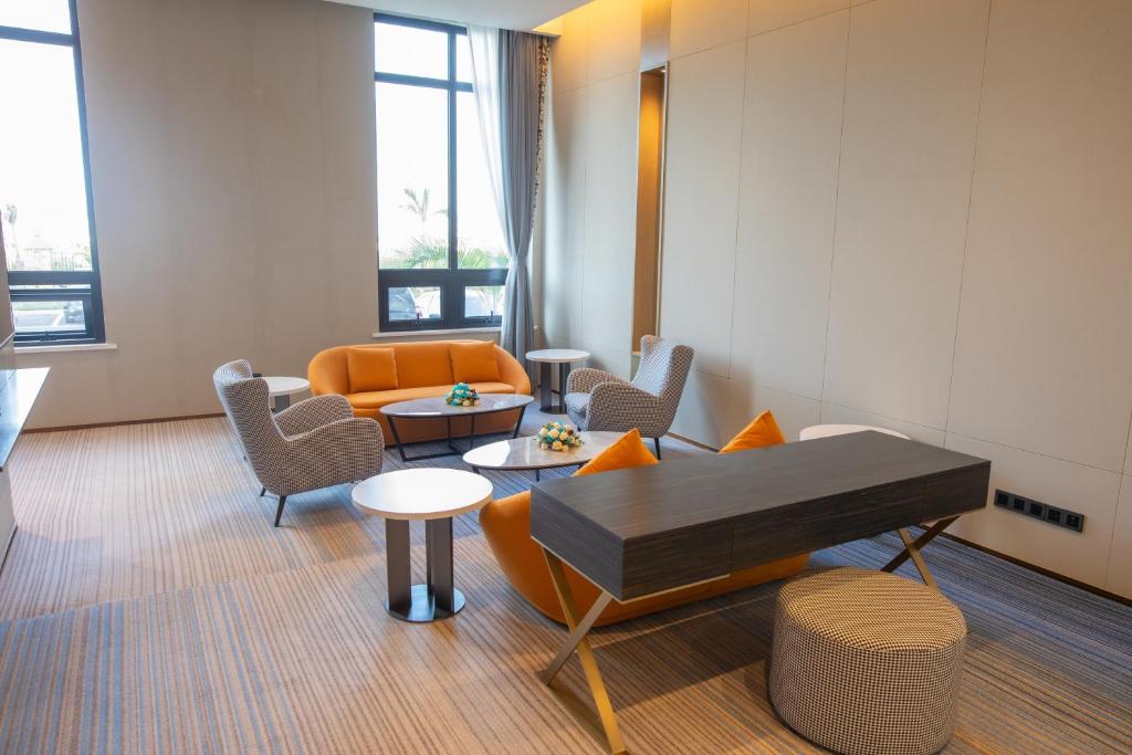 a living room with a couch and a piano at Argyle Grand Hotel Nairobi Airport in Nairobi