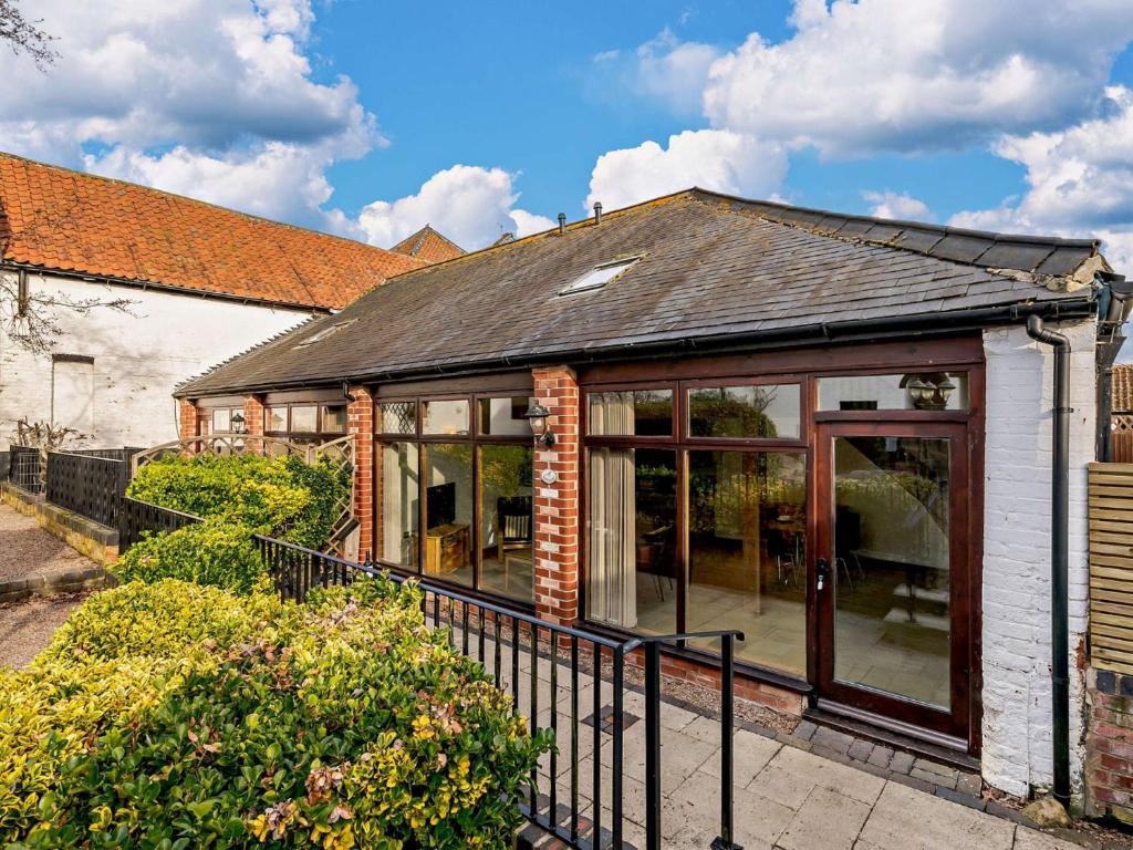 a house with a conservatory with glass doors at 1 Bed in Mattersey 91308 in Mattersey