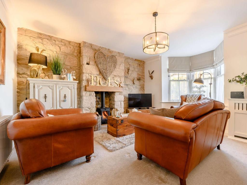a living room with two couches and a fireplace at 2 Bed in Alnwick 91316 in Alnwick