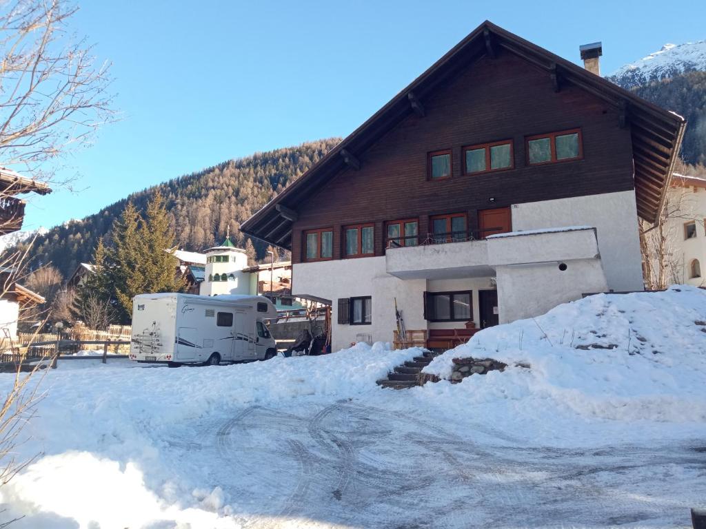 a house with a lot of snow in front of it at LakyFamily in Cogolo