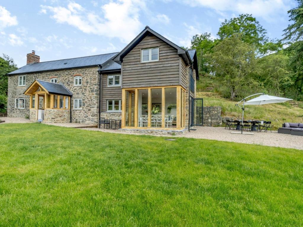 an image of a house with a lawn at 4 Bed in Old Churchstoke 91498 in Church Stoke