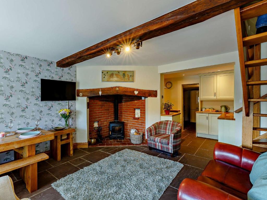 a living room with a fireplace and a kitchen at 2 Bed in Bridgnorth 91551 in Bridgnorth