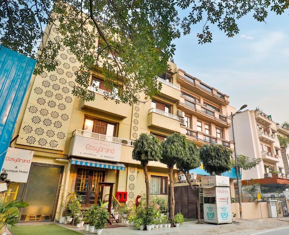 a building on the side of a street at Cosy Grand, Near Chanakyapuri, Embassy Area in New Delhi