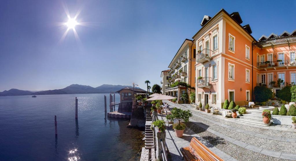 a group of buildings next to a body of water at Hotel Cannero in Cannero Riviera