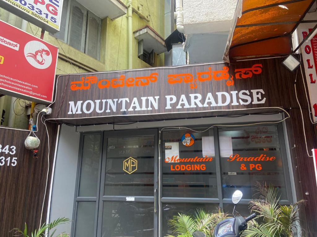a sign for a mountain parakeet on a building at HOTEL MOUNTAIN PARADISE in Bangalore