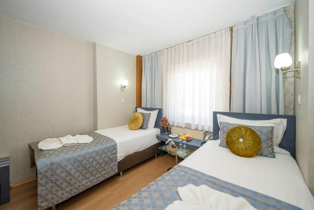Postel nebo postele na pokoji v ubytování Grand Ons Hotel