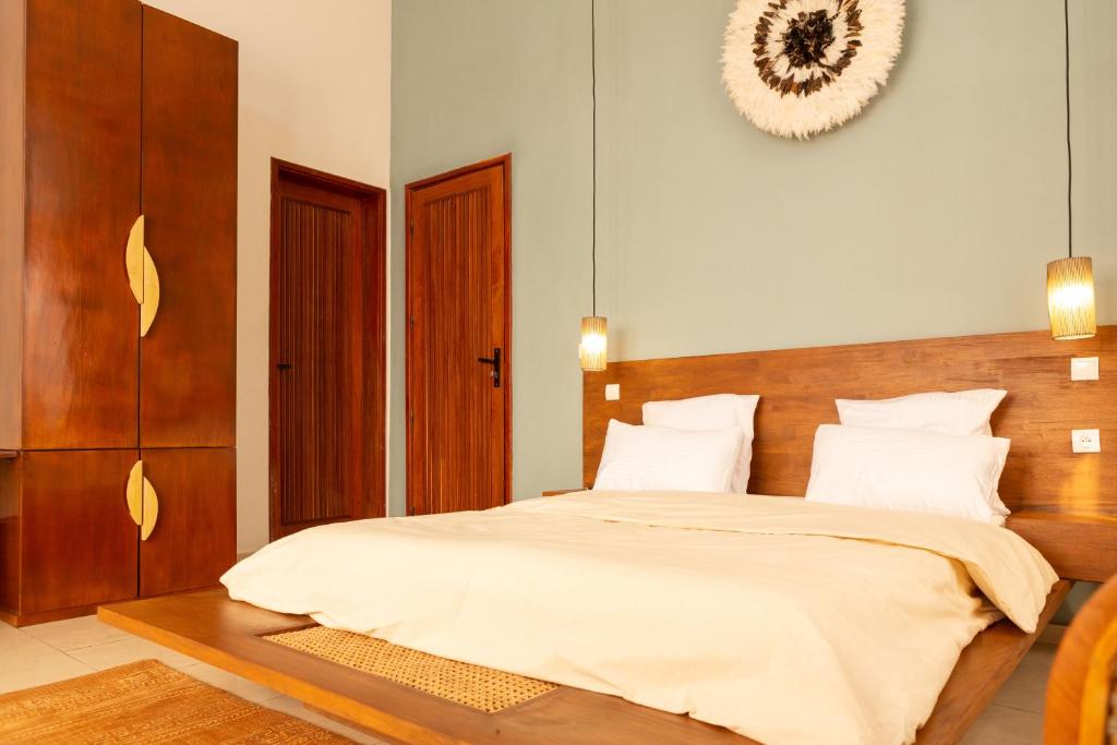 Postel nebo postele na pokoji v ubytování Tamarin Hôtel Cotonou
