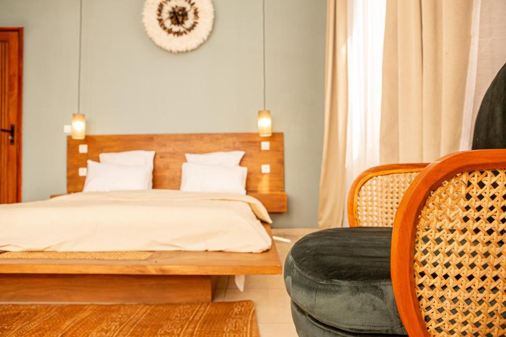 Postel nebo postele na pokoji v ubytování Tamarin Hôtel Cotonou
