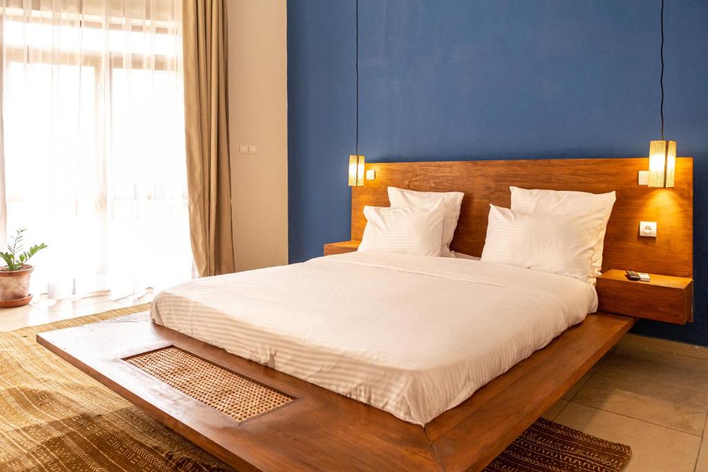 Postel nebo postele na pokoji v ubytování Tamarin Hôtel Cotonou