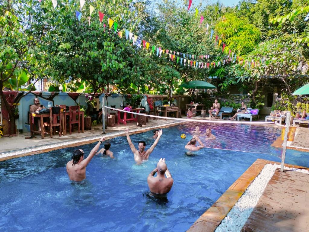 a group of people in a swimming pool at Blue Diamond Hostel in Battambang