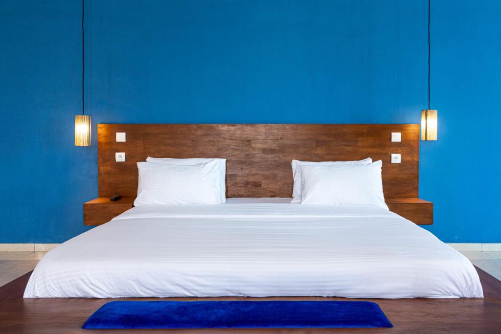 Postel nebo postele na pokoji v ubytování Tamarin Hôtel Cotonou