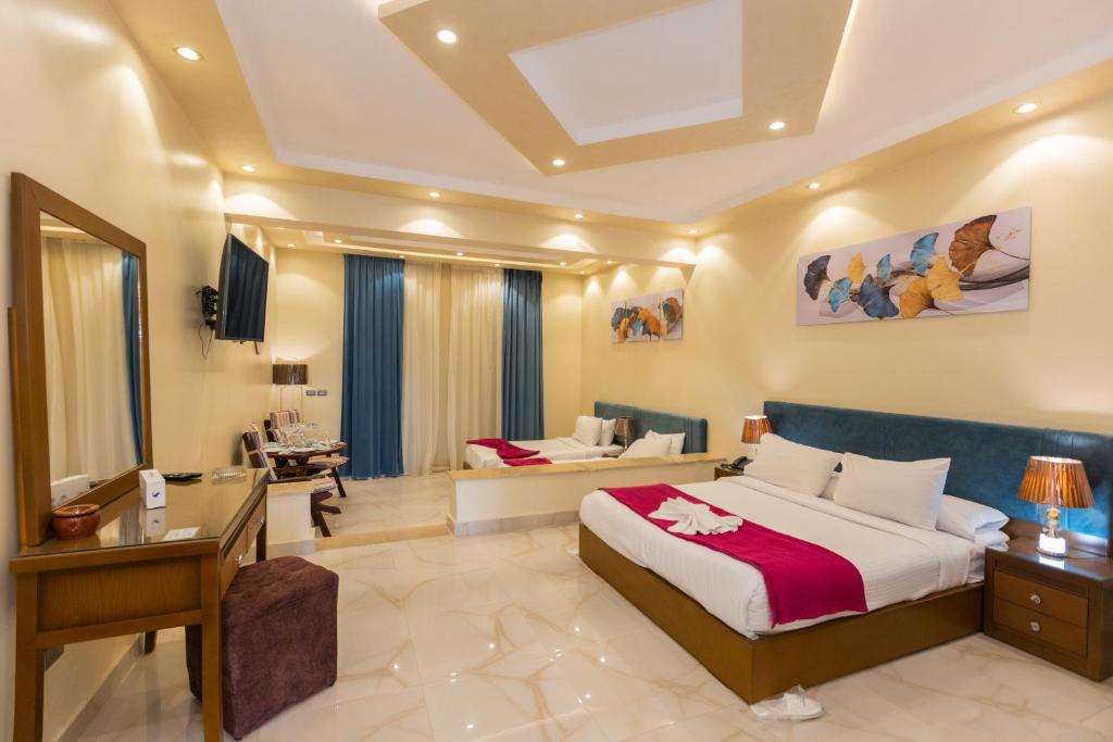 a bedroom with a bed and a desk and a couch at Ramage Hotel & Resort in Cairo