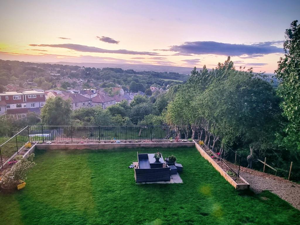 a garden with a couch on the grass at Cosy Corner Suite in Bradford