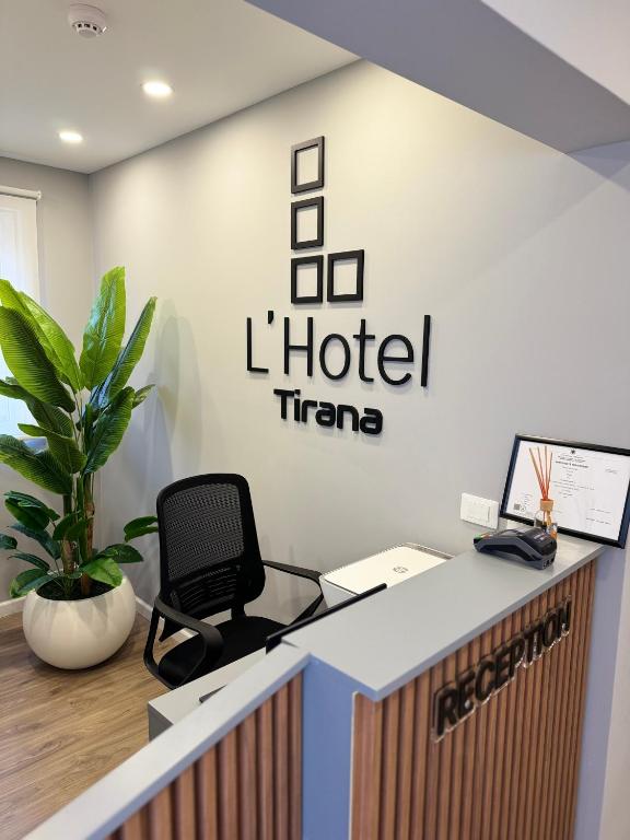 an office with a desk with a chair and a hotel at L’Hotel Tirana in Tirana