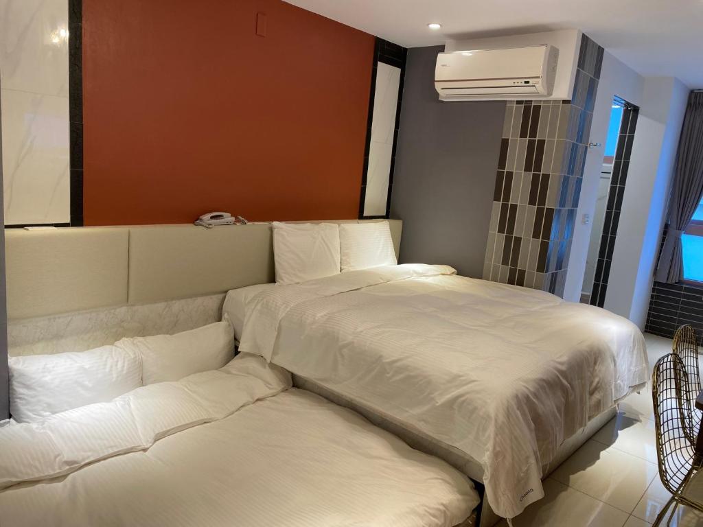 Postel nebo postele na pokoji v ubytování 安平商旅Choona Hotel Anping