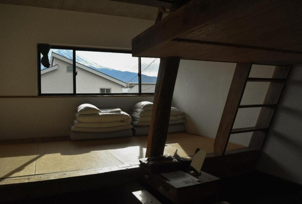 a view of a room with a window and a couch at kagelow Mt.Fuji Hostel Kawaguchiko in Fujikawaguchiko