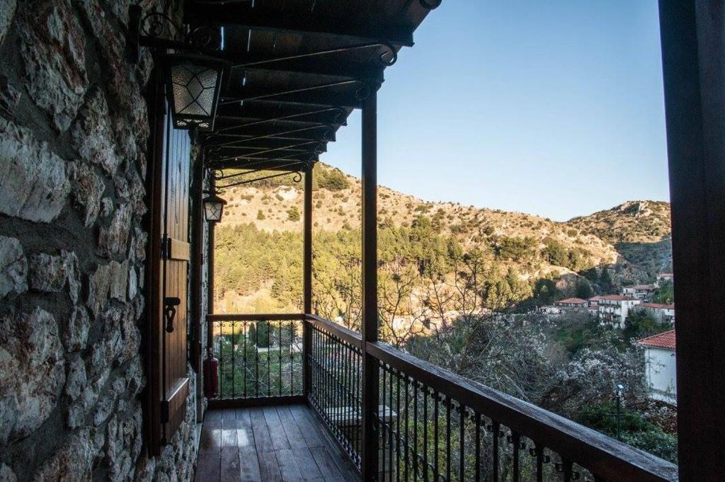a balcony of a building with a view of a mountain at Despotikon Dimitsana Guest house - Ξενώνας Δεσποτικόν Αντωνόπουλου in Dimitsana