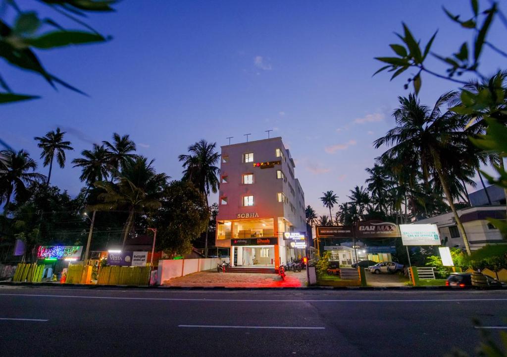 a building on the side of a street at night at POP TAVERN Delight by VOYE HOMES in Veli