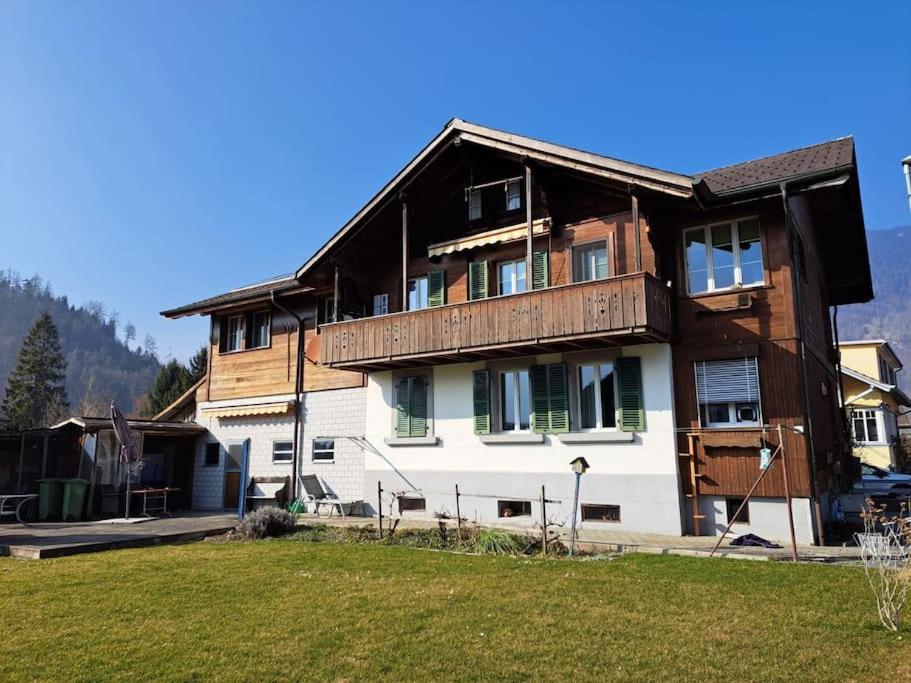 a large house with a wooden roof at Family-friendly apartment with Alpine view in Matten