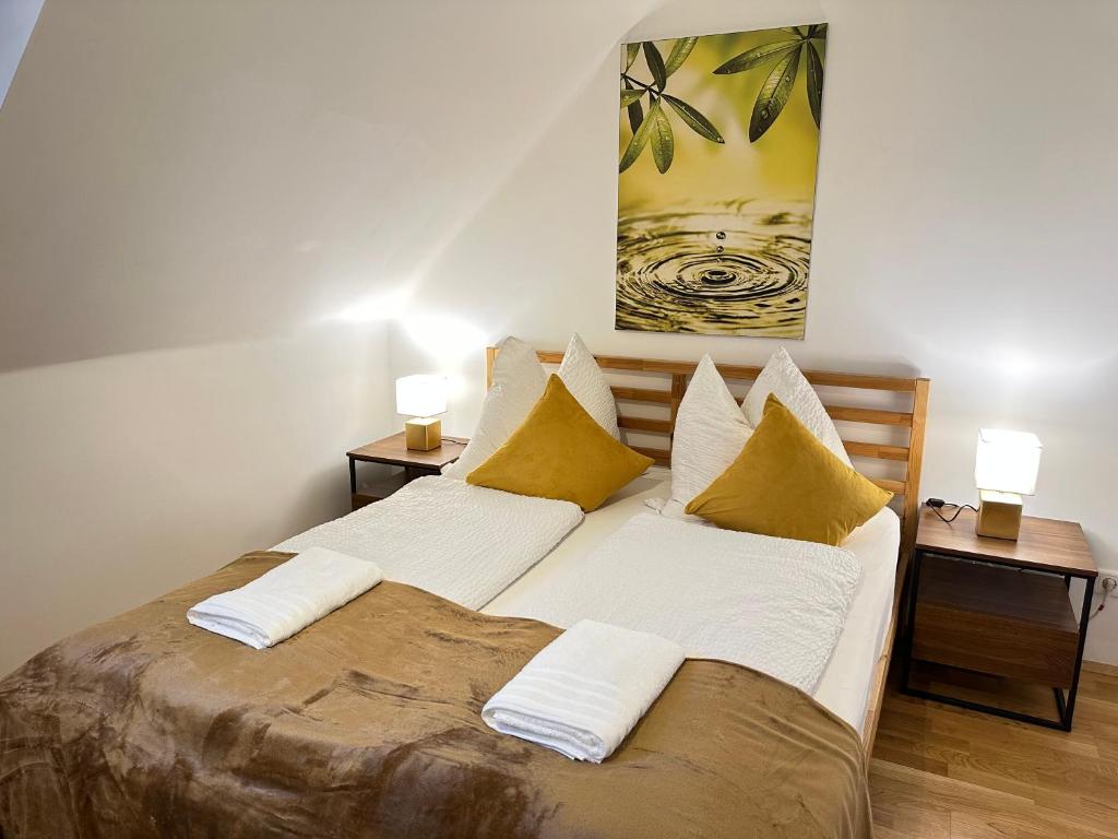 a bedroom with a large bed with two lamps at The Peaceful Garden Stay & Free Parking in Salzburg