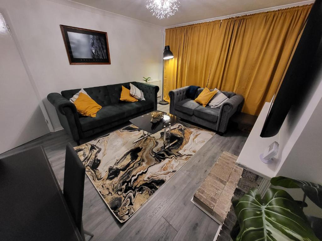 a living room with two couches and a table at Cosy 2 Bedroom flat in Grays in Grays Thurrock