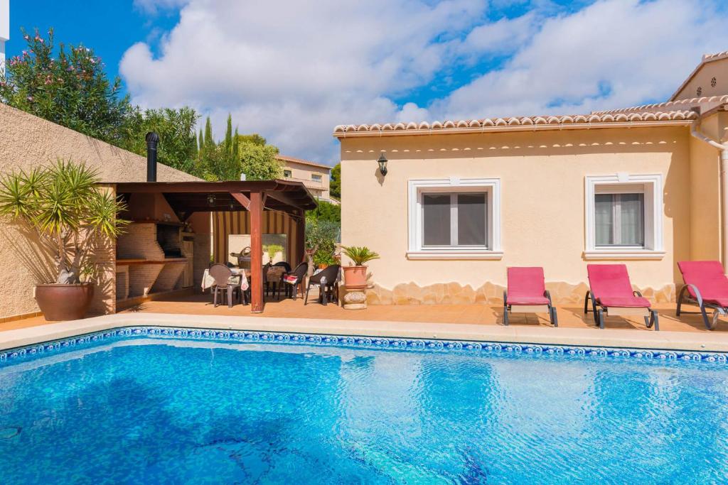 a villa with a swimming pool and a house at Villa Amelia - PlusHolidays in Ifach