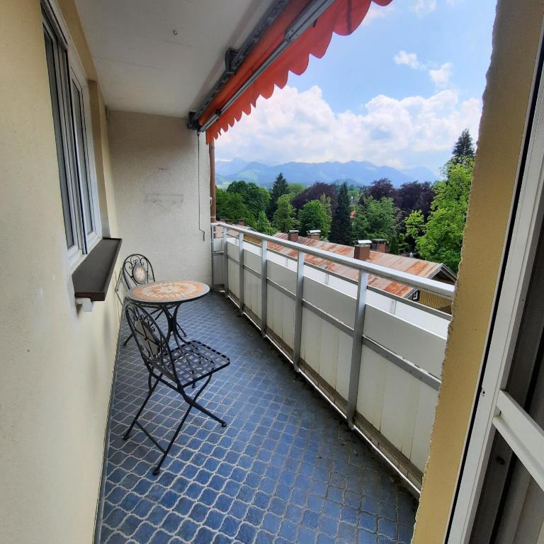 a balcony with a table and a view of the mountains at Allgäu Auszeit in Sonthofen