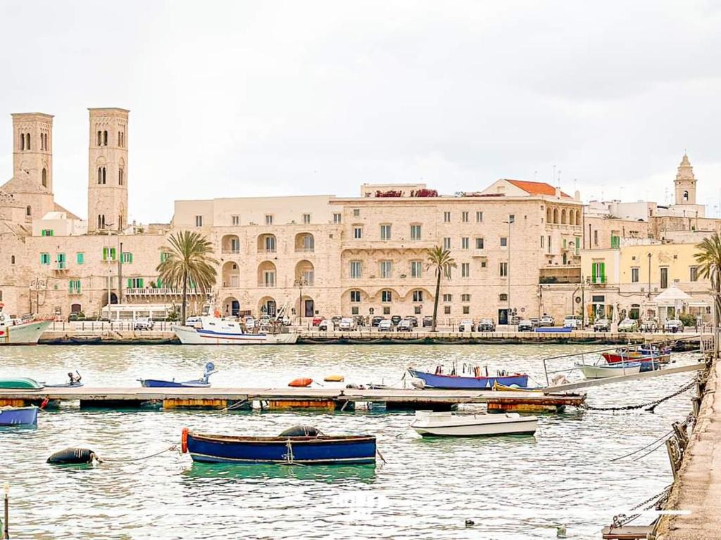 a group of boats in a body of water with buildings at DOGANA RESORT in Molfetta