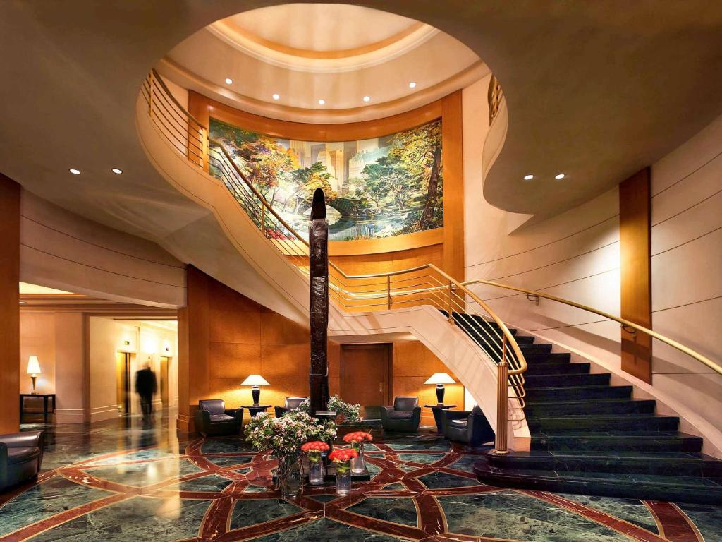 a lobby with a spiral staircase in a building at Sofitel New York in New York