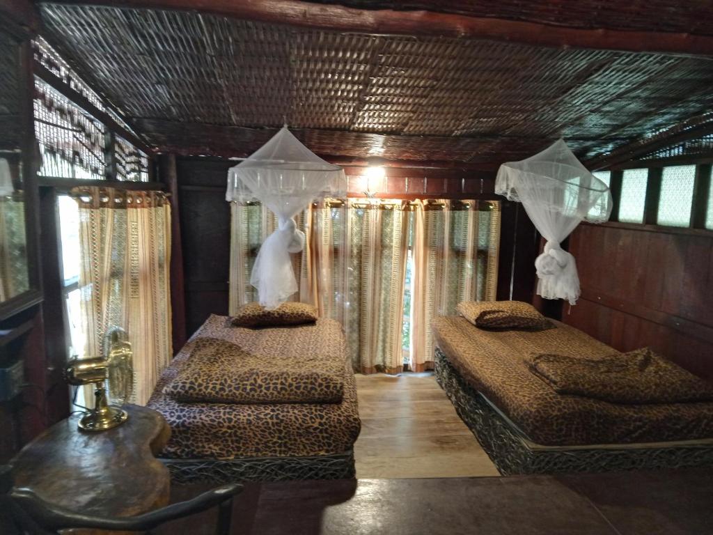 a bedroom with two beds in a house at Room 2 in Ban Tham