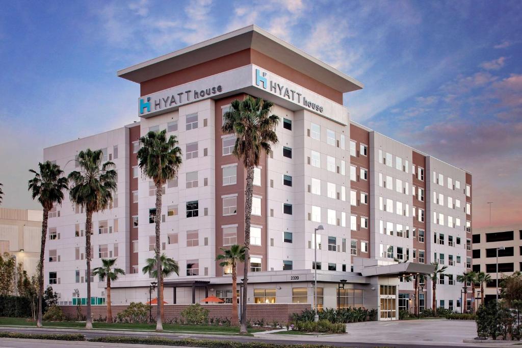 a rendering of a hotel with palm trees in front at Hyatt House Irvine/John Wayne Airport in Irvine